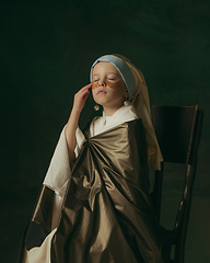 Image showing Medieval little girl as a lady with a pearl earring on dark studio background. Concept of comparison of eras, childhood. Stylish creative design, art vision, new look of artwork.