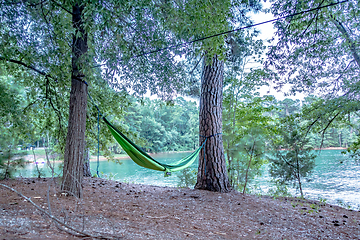 Image showing hammock hanging on trees by the lakeside