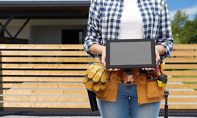 Image showing woman builder with working tools showing tablet pc