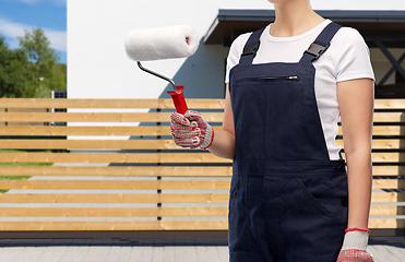 Image showing close up of painter or builder with paint roller