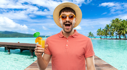 Image showing happy man in straw hat with juice on beach