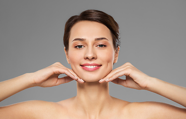 Image showing beautiful young woman touching her face and chin