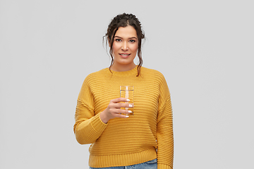 Image showing smiling young woman with water in glass