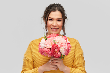 Image showing happy smiling young woman with bunch of flowers