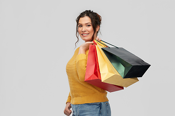 Image showing happy smiling young woman with shopping bags