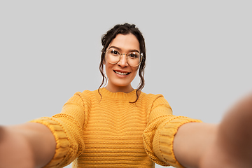 Image showing smiling woman with pierced nose taking selfie