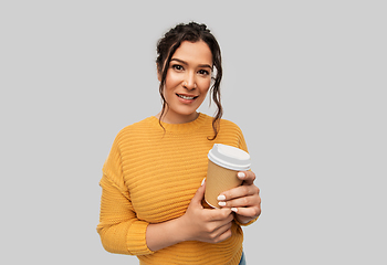 Image showing smiling woman with pierced nose holding coffee cup