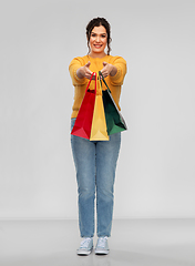 Image showing happy smiling young woman with shopping bags