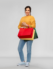 Image showing happy smiling young woman with shopping bags