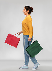 Image showing happy smiling young woman with shopping bags