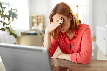 Image showing stressed woman with laptop working at home office