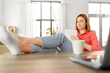 Image showing woman with notebook and laptop at home office