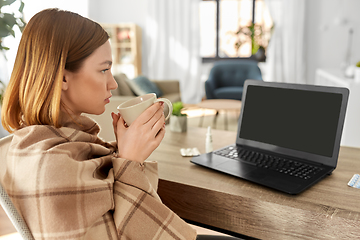 Image showing sick woman with tea having video call on laptop