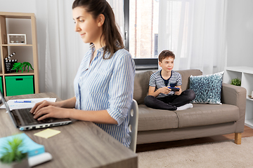 Image showing boy with gamepad playing video game at home