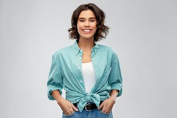 Image showing portrait of smiling young woman in turquoise shirt