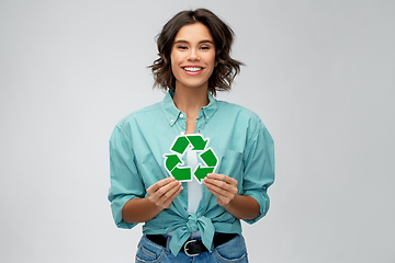 Image showing smiling young woman holding green recycling sign