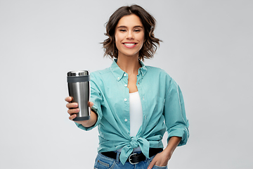 Image showing woman with thermo cup or tumbler for hot drinks