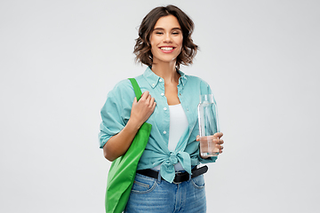 Image showing woman with bag for food shopping and glass bottle