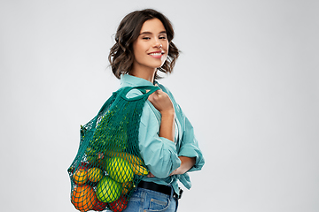 Image showing happy smiling woman with food in reusable net bag