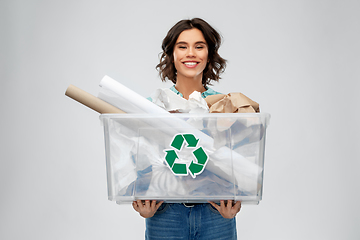 Image showing happy smiling young woman sorting paper waste