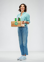 Image showing smiling young woman sorting glass waste