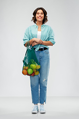 Image showing happy smiling woman with food in reusable net bag