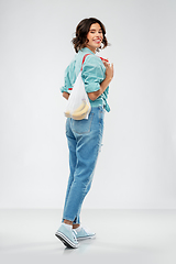 Image showing happy woman with bananas in reusable string bag