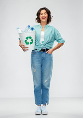 Image showing smiling young woman sorting plastic waste