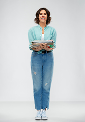 Image showing smiling young woman sorting paper waste