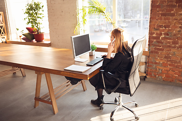 Image showing Caucasian young woman in business attire working in office