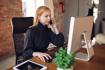 Image showing Caucasian young woman in business attire working in office