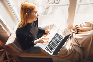 Image showing Young woman using gadgets to watch cinema, photos, online courses, taking selfie or vlog, online shopping