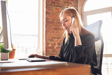 Image showing Caucasian young woman in business attire working in office