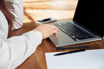 Image showing Caucasian young woman in business attire working in office