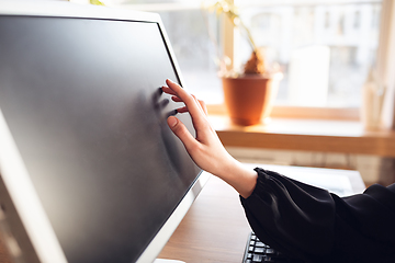 Image showing Caucasian young woman in business attire working in office