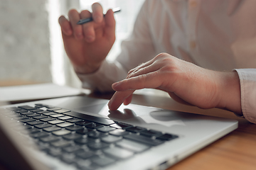 Image showing Caucasian young man in business attire working in office, job, online studying