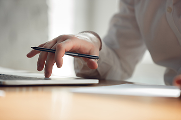 Image showing Caucasian young man in business attire working in office, job, online studying