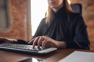 Image showing Caucasian young woman in business attire working in office