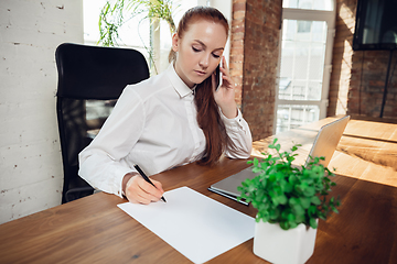 Image showing Caucasian young woman in business attire working in office