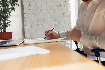 Image showing Caucasian young man in business attire working in office, job, online studying