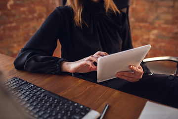 Image showing Caucasian young woman in business attire working in office