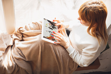 Image showing Young woman using gadgets to watch cinema, photos, online courses, taking selfie or vlog, online shopping