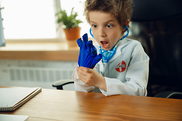 Image showing Little caucasian boy as a doctor consulting for patient, working in cabinet, close up