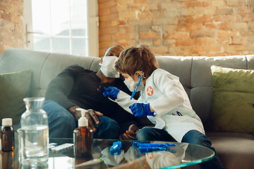 Image showing Little caucasian boy as a doctor consulting for patient, working in cabinet, close up