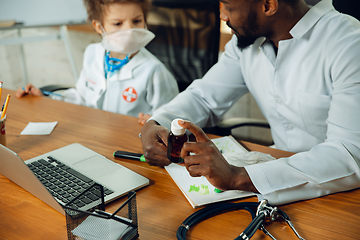 Image showing Little caucasian boy as a doctor consulting for patient, working in cabinet, close up