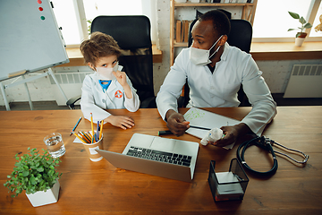 Image showing Little caucasian boy as a doctor consulting for patient, working in cabinet, close up