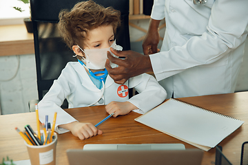 Image showing Little caucasian boy as a doctor consulting for patient, working in cabinet, close up