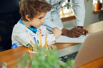 Image showing Little caucasian boy as a doctor consulting for patient, working in cabinet, close up