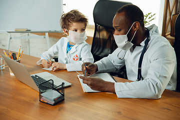 Image showing Little caucasian boy as a doctor consulting for patient, working in cabinet, close up