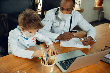 Image showing Little caucasian boy as a doctor consulting for patient, working in cabinet, close up